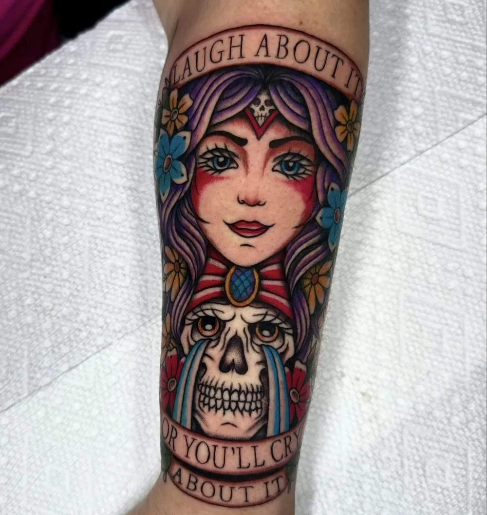 Woman over a weeping skull with "Laugh about it or you'll cry about it" banners, color traditional