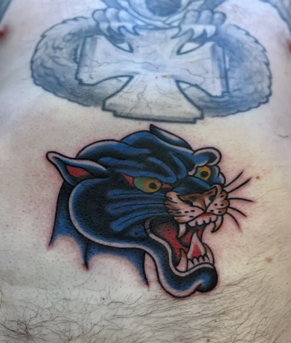 Snarling blue panther head, color traditional tattoo