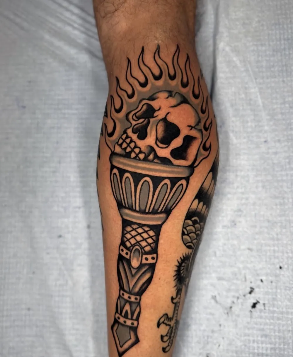 Flaming skull torch, black and grey traditional tattoo
